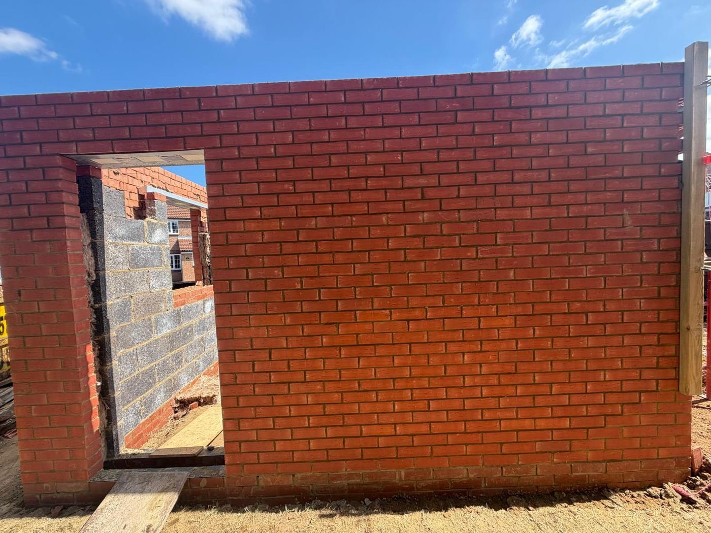 Door and window openings formed with steel lintels installed